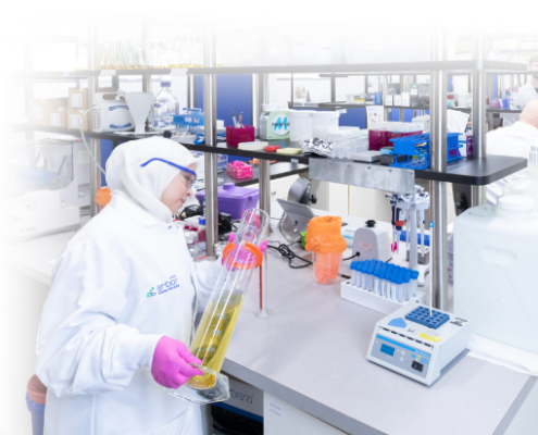 Scientist pouring liquid into a graduated cylinder